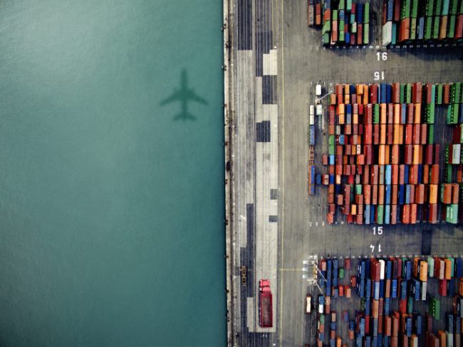 orig-plane-shadow-over-containder-port-Getty-636036276-700×525