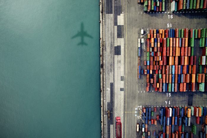 orig-plane-shadow-over-containder-port-Getty-636036276-700×525