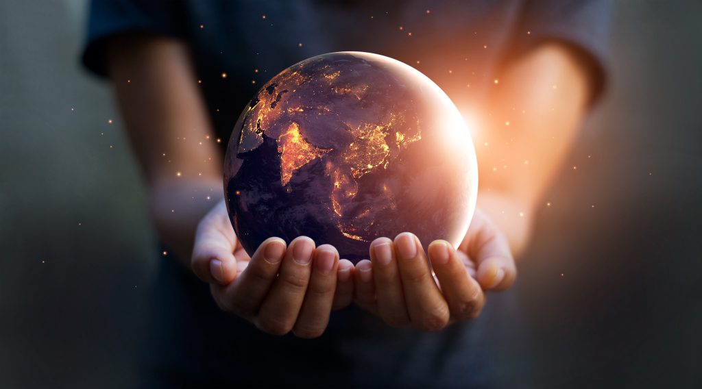 Earth at night was holding in human hands. Earth day. Energy sav