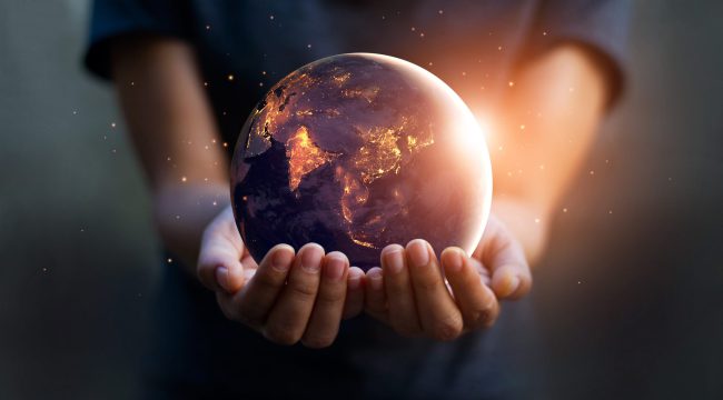 Earth at night was holding in human hands. Earth day. Energy sav